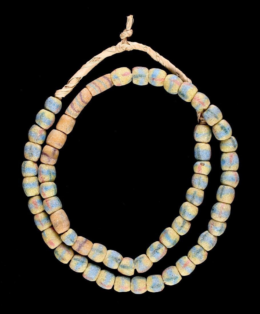 25" Trade Bead Necklace: Sand cast beads with yellow, blue, red, and brown colors.