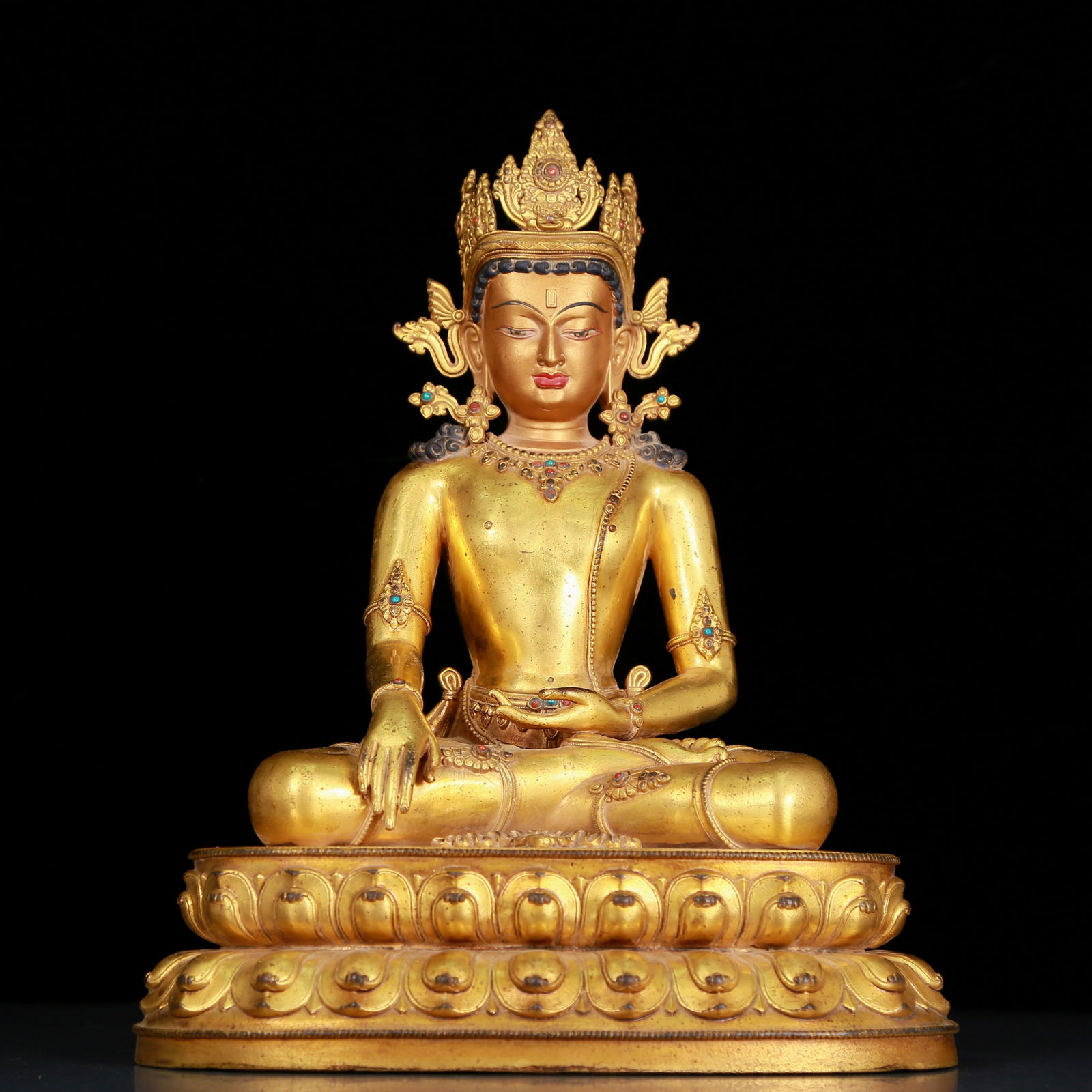 A huge gilt bronze inlaid turquoise seated statue of the longevity Buddha: A huge gilt bronze inlaid turquoise seated statue of longevity Buddha, with inscription, Ming Dynasty, China. The Buddha's face has clear outlines, deep eyes, a solemn and kind expression, and the cor