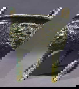 An Archaic Bronze Taotie Pattern Double-Ears and Tripod Censer: An Archaic Bronze Taotie Pattern Double-Ears and Tripod Censer,Shang and Zhou Dynasty, China,Size:21.5cmx17.5cmx17.5cm,Weight:2.25kg 
