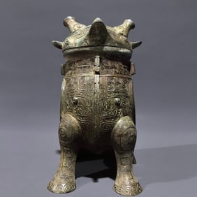 An Archaic Bronze Cloud and Thunder Pattern Ancient Owl-Shaped Zun