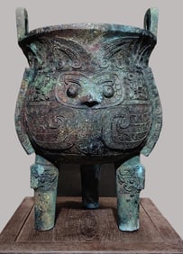 An Archaic Bronze Ding Tripod with Owl Masks and Twin Handles