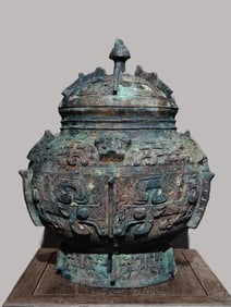 An Archaic Bronze Lei with Taotie Beast Mask