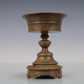 A Rare Bronze-body candlestick