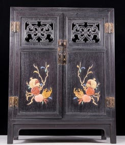 An exquisite zitanwood cabinet inlaid with gems and patterns of fortune, wealth, longevity and
