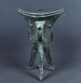 An Archaic Bronze Cloud and Thunder Pattern Tripod Goblet