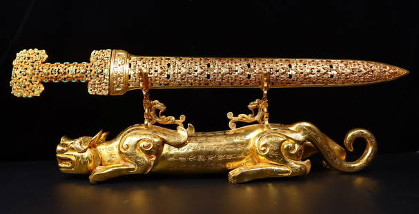 An Exquisite Gilt Bronze Phoenix Pattern Chi-Dragon Pattern Sword: An Exquisite Gilt Bronze Phoenix Pattern Chi-Dragon Pattern Sword Qing Dynasty, China Size:7.9inx21.7inx5.5in