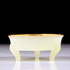 An exquisite white jade tripod basin covered with gold
