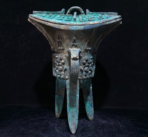 An Archaic Bronze Beast-Face Pattern Tripod Goblet