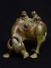 An Archaic Bronze boy riding ox