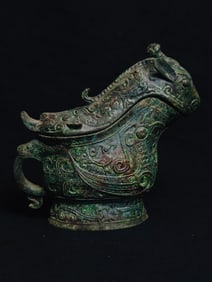 An Archaic Bronze animal face wine cup