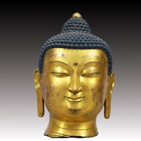 A Solemn Gilt Bronze Buddha Head Ornament