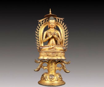 A solemn gilt bronze statue of Sakyamuni