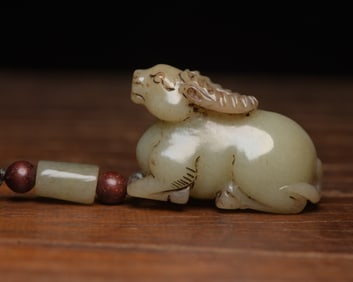 An Exquisite White Jade Buffalo Pendant