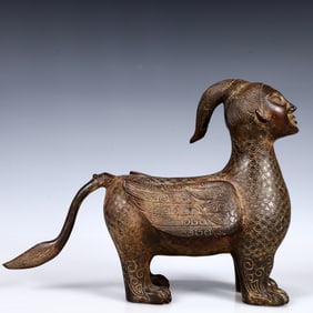 A Rare Bronze Human-Face Beast Ornament