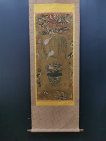 A vertical scroll of Chinese ink flower and bird painting on silk