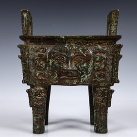 A Rare Bronze Human-Face Pattern Ding