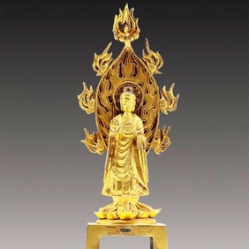 A solemn gilt bronze statue of Sakyamuni