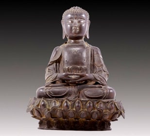 A solemn bronze statue of Gautama Buddha