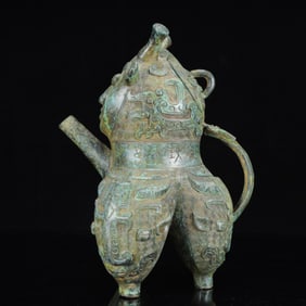 An Archaic Bronze Figure-Face Pattern Tripod Ewer,with Inscription