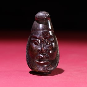 An Exquisite Gaogu Jade Human-face Pattern Hand Piece