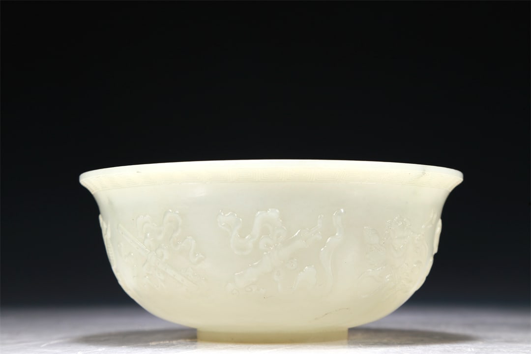 A Marvelous White Jade 'Weapons Of The Eight Immortals' Bowl (1 of 5)