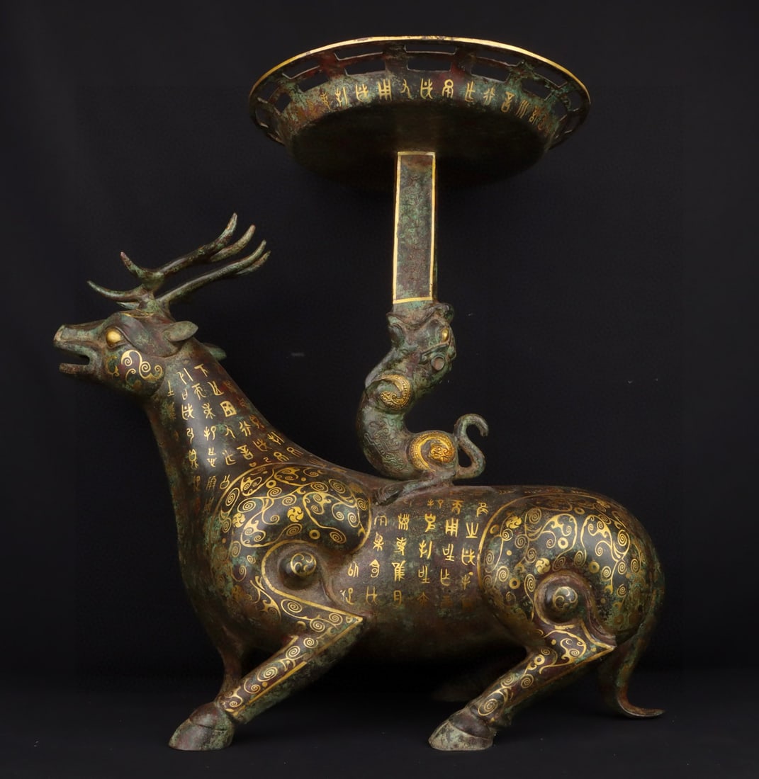 An Exquisite Bronze Inlaid Gold With Inscription Deer-Shaped Candlestick: An Exquisite Bronze Inlaid Gold With Inscription Deer-Shaped Candlestick Han Dynasty, China Size:27.6inx22.8in Weight:16450g青铜错金鹿灯 中国汉