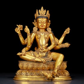 A stunning gilt bronze six-armed Guanyin statue
