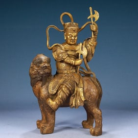 A Solemn Gilt Bronze Statue of Dharma Protector Rides the Lion