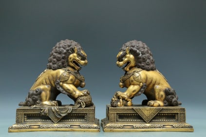An Archaic Pair Of Gilt-Bronze Lions