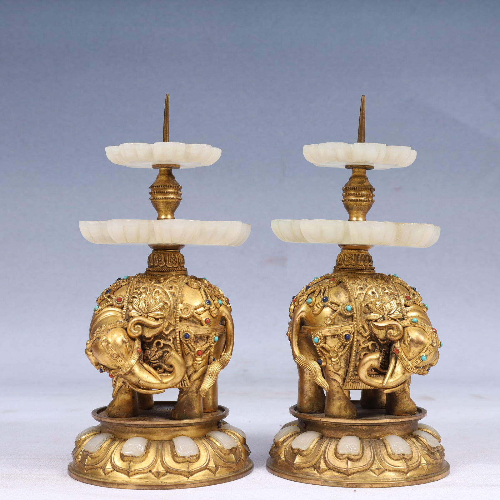A Pair of Exquisite Gilt Bronze Inlaid White Jade Elephant-Shaped Candlesticks,Inlaid Gems: A Pair of Exquisite Gilt Bronze Inlaid White Jade Elephant-Shaped Candlesticks,Inlaid Gems,Qing Dynasty, China,Qianlong Four-character Mark,Size:3.9inx4.7in,Weight:1700g 一对铜ແ
