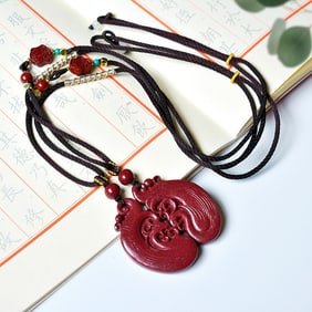 A Pair of Exquisite Cinnabar Dragon and Phoenix Pendants