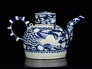 A Rare Blue and White Reserved White Phoenix Pattern Ewer