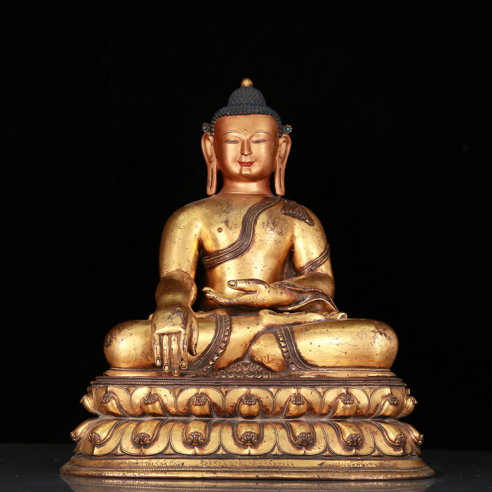A Fabulous Gilt-Bronze Figure Of Buddha Shakyamuni With Inscriptions: A Fabulous Gilt-Bronze Figure Of Buddha Shakyamuni With Inscriptions. Superbly and sensitively sculpted in the form of a seated Buddha Shakyamuni, with well-defined arched eyebrows juxtaposed with the