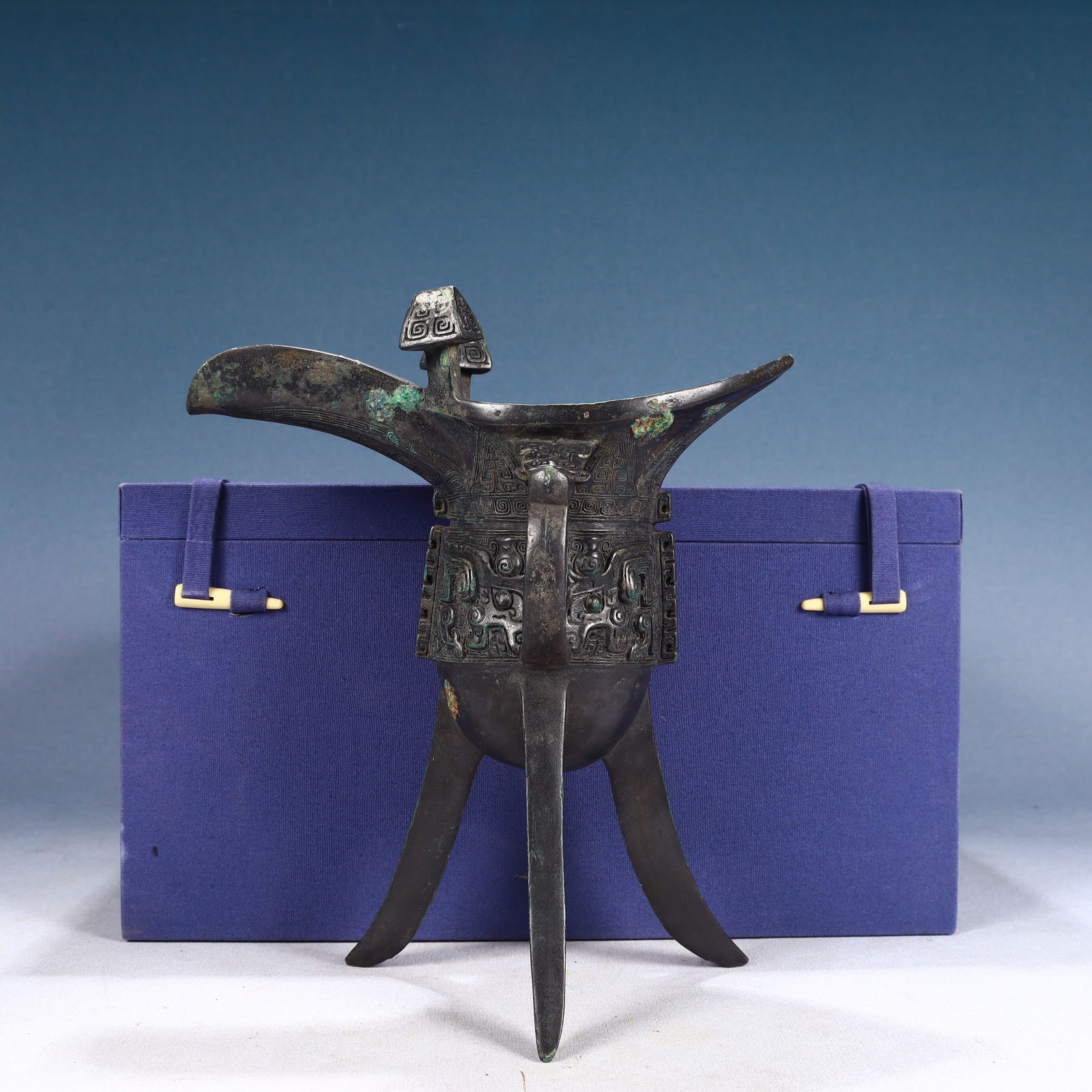 An Archaic Bronze Beast-Face Pattern Tripod Goblet: An Archaic Bronze Beast-Face Pattern Tripod Goblet,Qing Dynasty, China,Size:8.3inx3.9inx9.4in,Weight:1400g 青铜兽面纹三足爵杯,中国