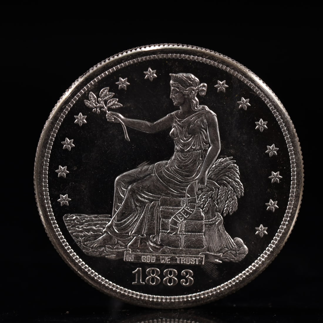 USA Trade Dollar 1883 Coin: American coin. Obverse: Liberty seated on a pedestal facing the sea to the left holding olive branches surrounded by 13 stars. IN GOD WE TRUST / LIBERTY / 1883. Reverse: An eagle holding branches