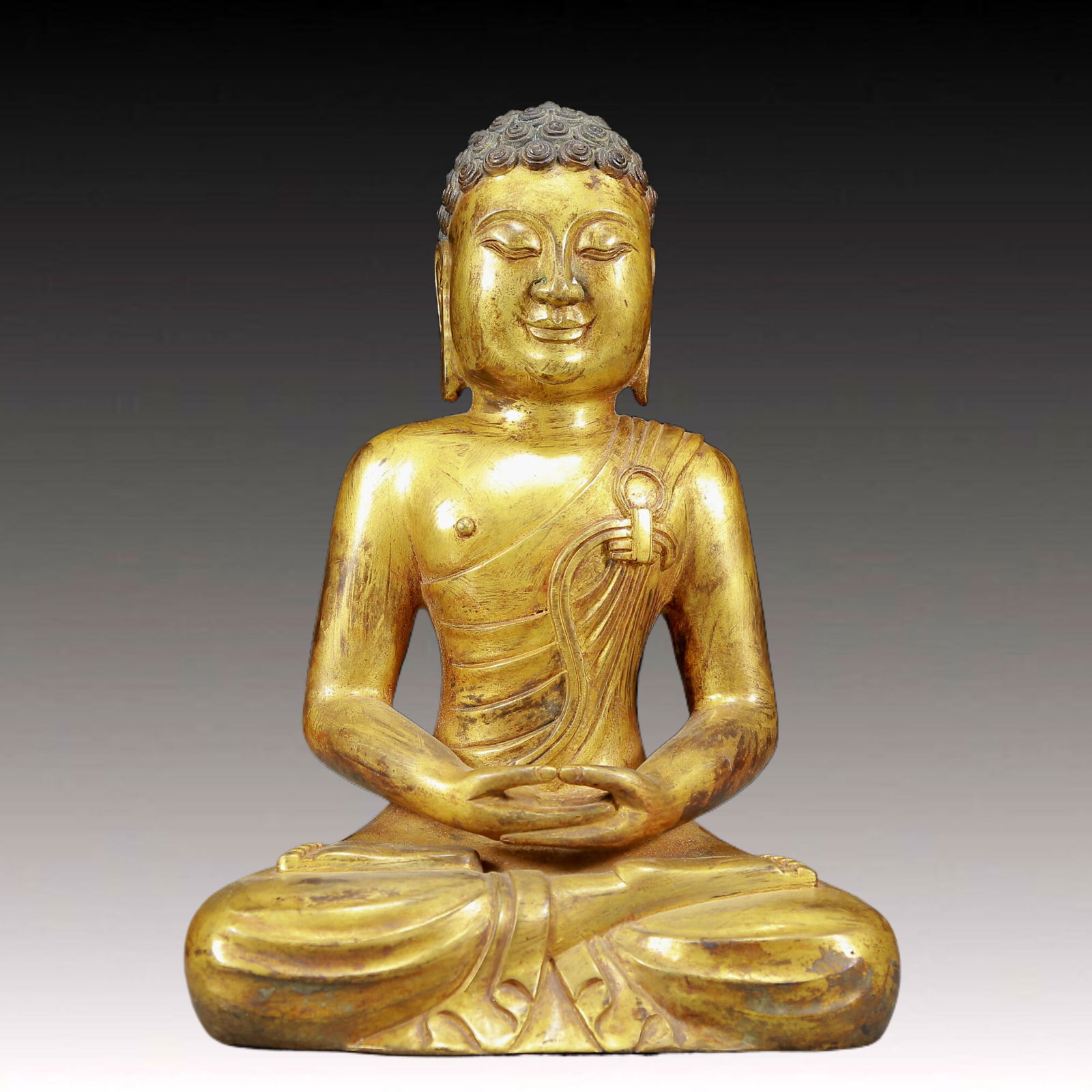 A Solemn Gilt Bronze Statue of Sakyamuni: A Solemn Gilt Bronze Statue of Sakyamuni,Ming Dynasty, China,Size:7.1inx4.3inx9.8in,Weight:2325g 铜鎏金释迦摩尼像，明代