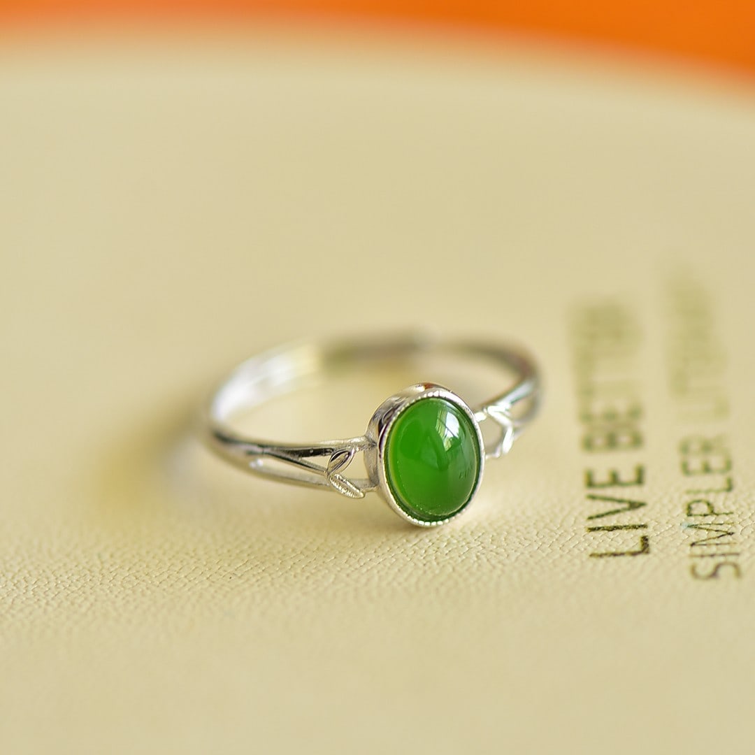 An Exquisite Sterling Silver Inlaid White Jade Ring: Sterling Silver Inlaid White Jade Ring , Size :0.2inx0.3in 纯银镶白玉戒指,尺寸:0.2inx0.3in