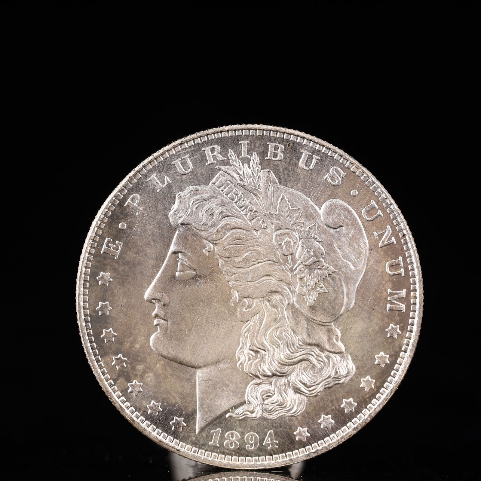 USA Morgan Dollar 1894 Coin: Obv: profile bust with date below and E PLURIBUS UNUM legend and stars around. Rev: eagle with In God we trust above within wreath with UNITED STATES OF AMERICA ONE DOLLAR legend. IN GOD WE TRUST /
