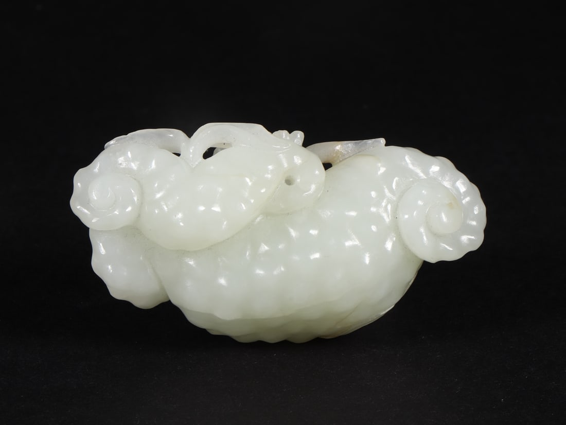 An Exquisite White Jade Flower Pattern Ornament: An Exquisite White Jade Flower Pattern Ornament Qing Dynasty, China Size:2.8inx1.5inx1in Weight:72g白玉花卉纹摆件 中国清代 Size:7.1cmx