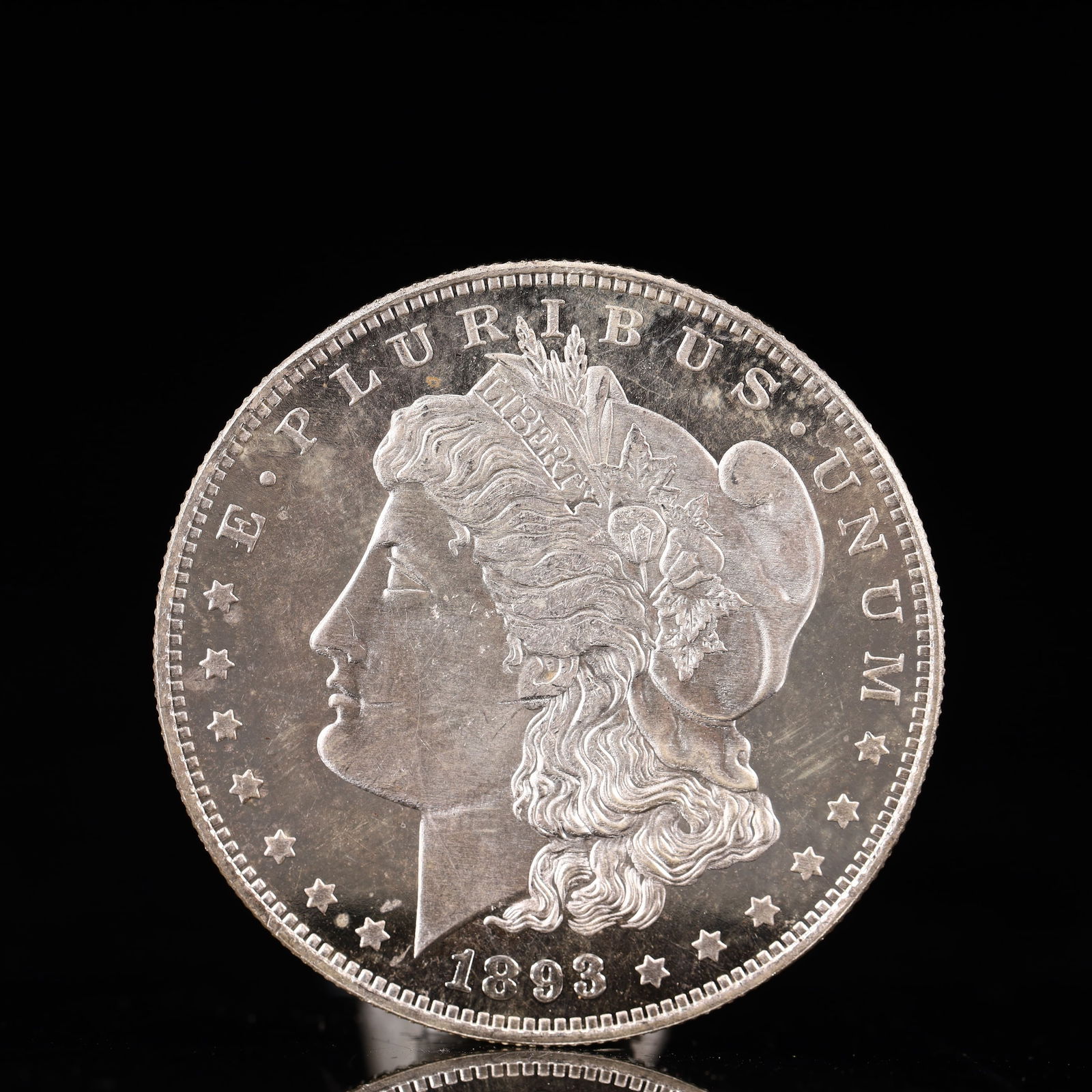 USA Morgan Dollar 1893 Coin: Obv: profile bust with date below and E PLURIBUS UNUM legend and stars around. Rev: eagle with In God we trust above within wreath with UNITED STATES OF AMERICA ONE DOLLAR legend. IN GOD WE TRUST / LI