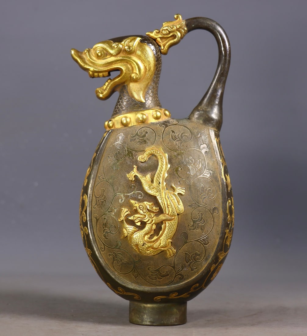 An Exquisite Gilt Bronze Dragon Pattern Lotus Pattern Ewer: An Exquisite Gilt Bronze Dragon Pattern Lotus Pattern Ewer Tang Dynasty, China Zhenguan Four-character Mark Size:8.7inx3.9inx2.8in Weight:778g铜鎏金龙壶 中国&