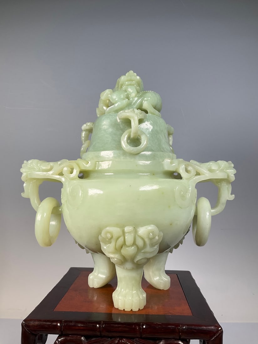 An Exquisite Serpentine Jade Beast-Face Pattern Double-Ears and Tripod Censer: An Exquisite Serpentine Jade Beast-Face Pattern Double-Ears and Tripod Censer Qing Dynasty, China Size:9.8inx9.1in Weight:3949g岫玉龙钮三足香炉 中