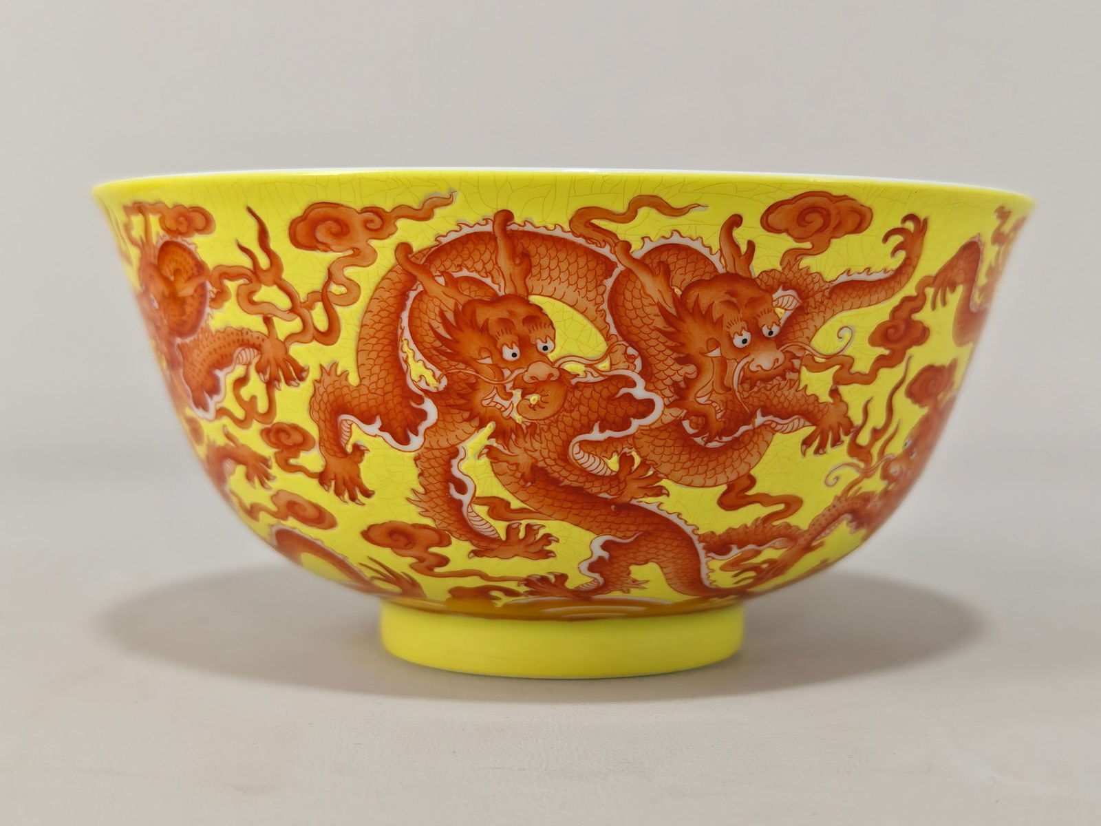 An Exquisite Famille-Rose Iron-Red Dragon Pattern Bowl: An Exquisite Famille-Rose Iron-Red Dragon Pattern Bowl Qing Dynasty, China Kangxi Four-character Mark Size:2.8inx5.6in粉彩黄底矾红九龙纹碗