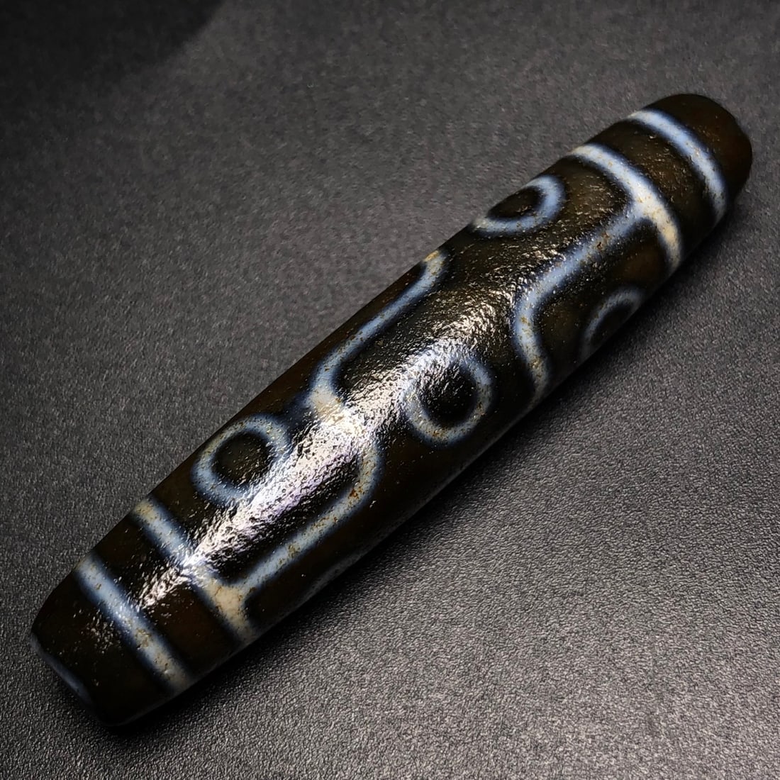 An Exquisite Nine Eyes Dzi Bead Pendant: An Exquisite Nine Eyes Dzi Bead Pendant,Size:57mmx12mm,Weight:12.8g 九眼天珠挂件