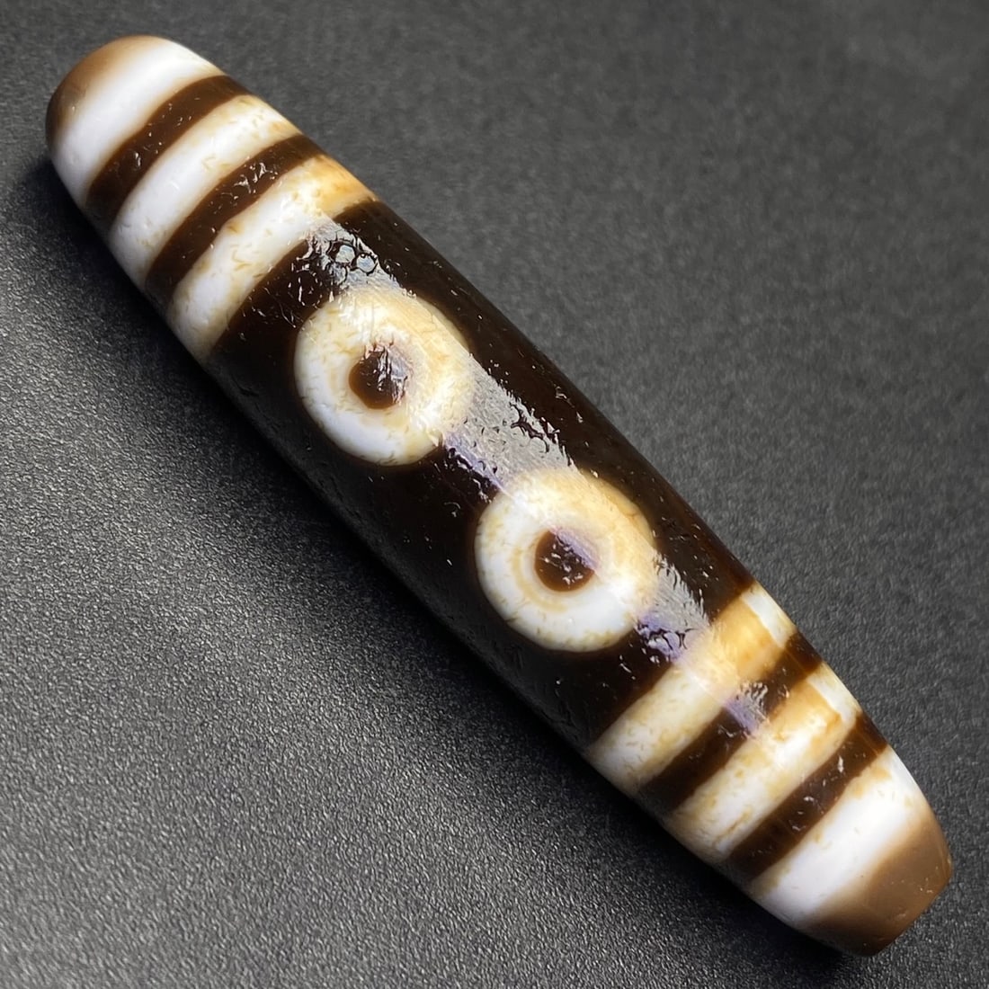 An Exquisite Five Eyes Dzi Bead Pendant: An Exquisite Five Eyes Dzi Bead Pendant,Size:55.5mmx12mm,Weight:12.7g 五眼天珠挂件