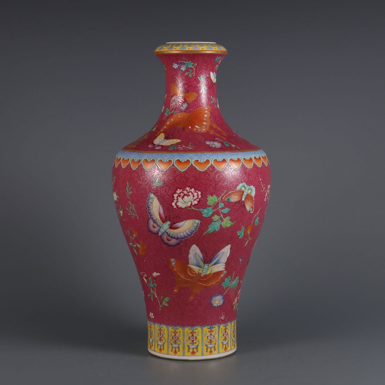 A Rare Carmine Red Ground Famille Rose Butterfly and Flower Pattern Vase: A Rare Carmine Red Ground Famille Rose Butterfly and Flower Pattern Vase,Qing Dynasty, China,Qianlong Six-character Mark,Size:12.9inx6.3in 