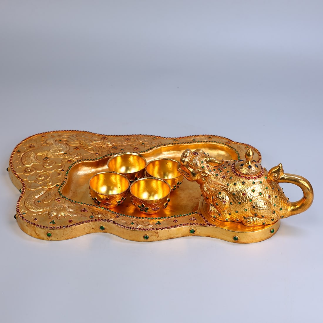 A Set of Exquisite Bronze Gilt Gem-Inlaid Auspicious Beast-Shaped Tea Set: A Set of Exquisite Bronze Gilt Gem-Inlaid Auspicious Beast-Shaped Tea Set,Qing Dynasty, China,Size:5.5inx17.3inx1.6inx2.4inx4.7inx7.9inx1.1inx16.9in,Weight:3150g 