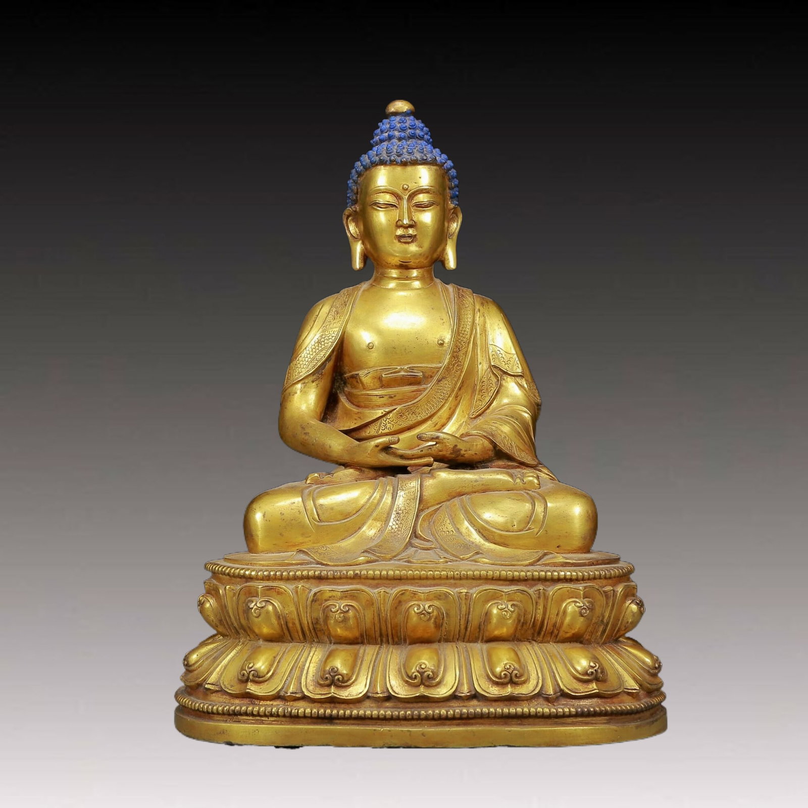 A Solemn Gilt Bronze Statue of Sakyamuni: A Solemn Gilt Bronze Statue of Sakyamuni,Qing Dynasty, China,Qianlong Seven-character Mark,Size:10.2inx7.9inx11.8in,Weight:9095g 铜鎏金释迦摩尼像，