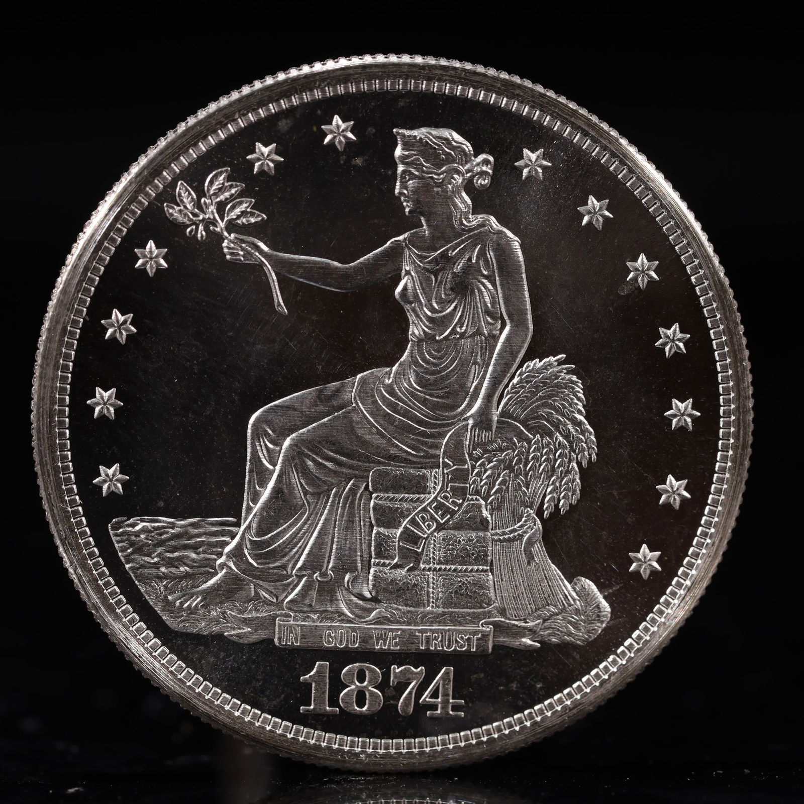 USA Trade Dollar 1874 Coin: American coin. Obverse: Liberty seated on a pedestal facing the sea to the left holding olive branches surrounded by 13 stars. IN GOD WE TRUST / LIBERTY / 1874. Reverse: An eagle holding branches with