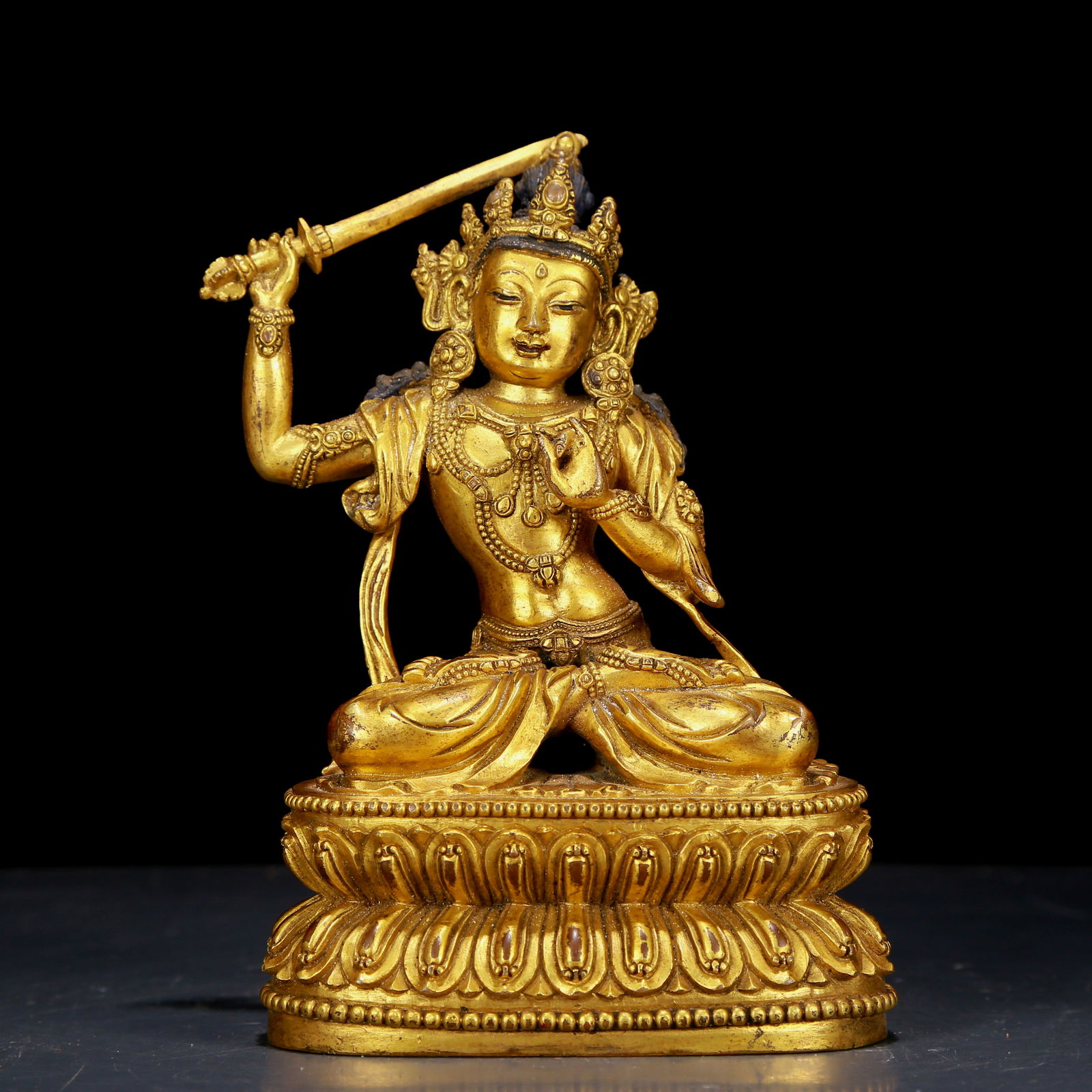 An exquisite gilt bronze statue of Manjusri Bodhisattva holding a sword (1 of 5)